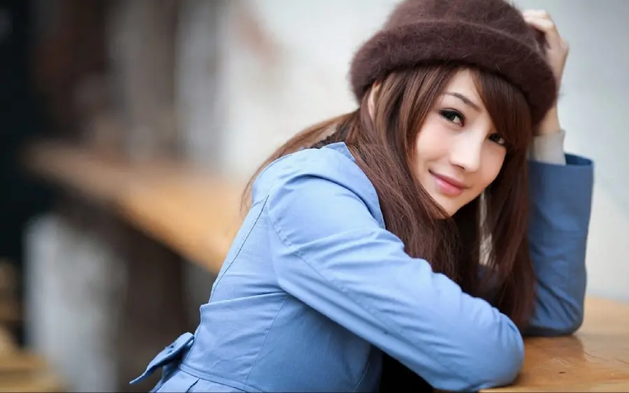 The best portrait of a brown-haired girl with a delicate and kind face in a blue dress