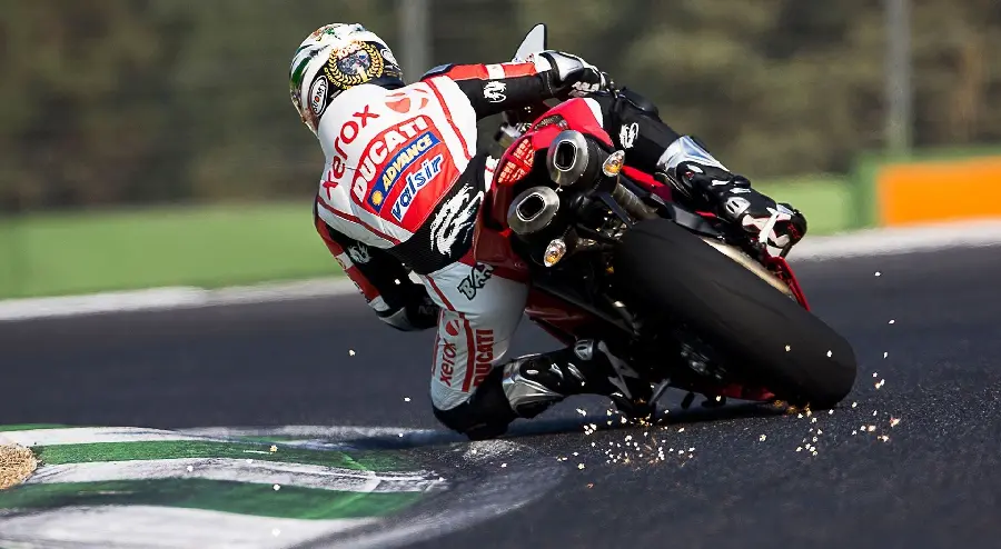 Photo of a motorcycle lying down on a bend