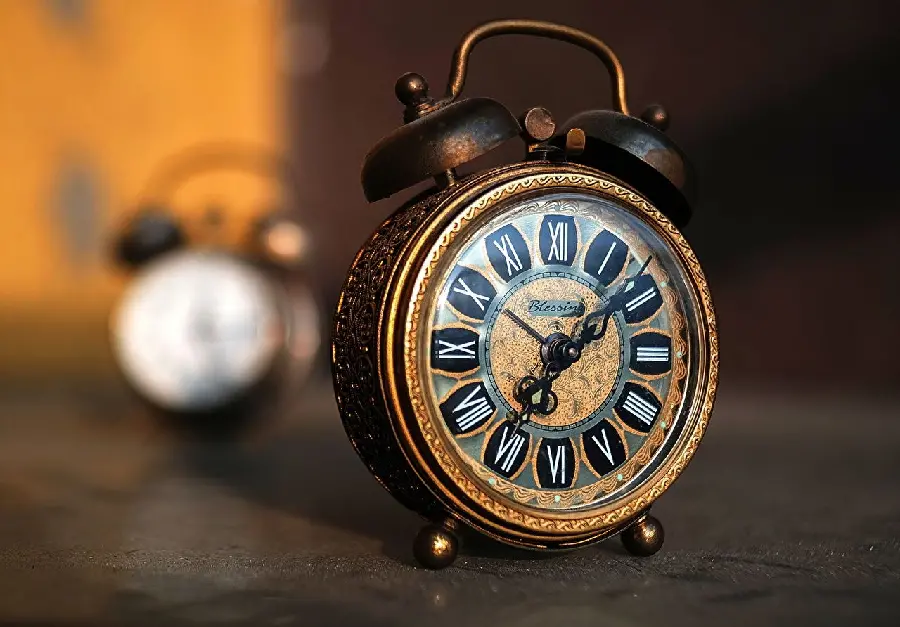 The best artistic photo of an old alarm clock with Roman numerals suitable for a post