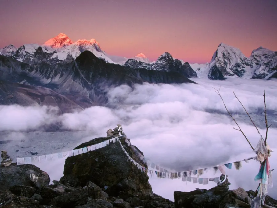 Spiritual photo of temples in Tibet above misty mountains
