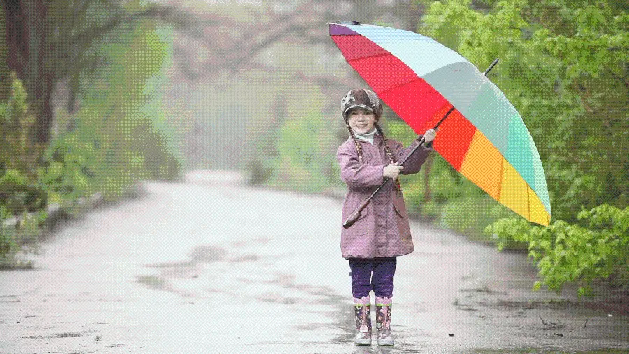 Beautiful Photo of Happy Little Girl and Rainbow Umbrella Under Rain