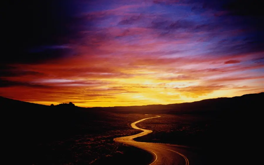Photo of a mountain road and sunset