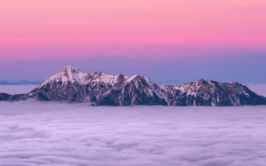 Cloudy mountain peaks in the beautiful halo of sunset 1402