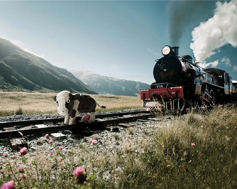 A fake Googly background of a beautiful calf on a train track