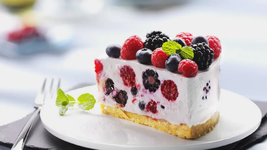 Photo of a cream cheesecake with a tempting strawberry decoration