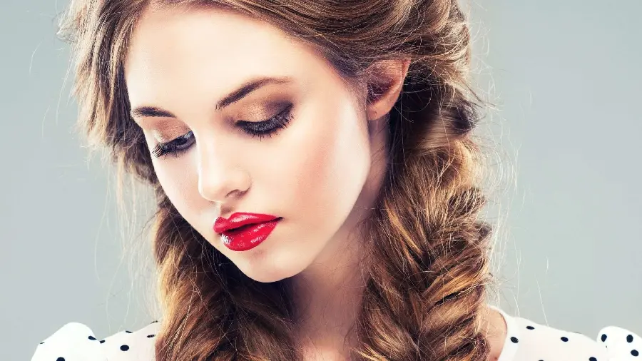 Full HD photo of a mellow and beautiful girl with red lipstick and braided hair