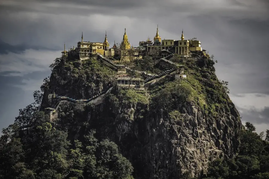 Interesting Picture of the Golden Temple in Tibet in the Dark Green Mountains