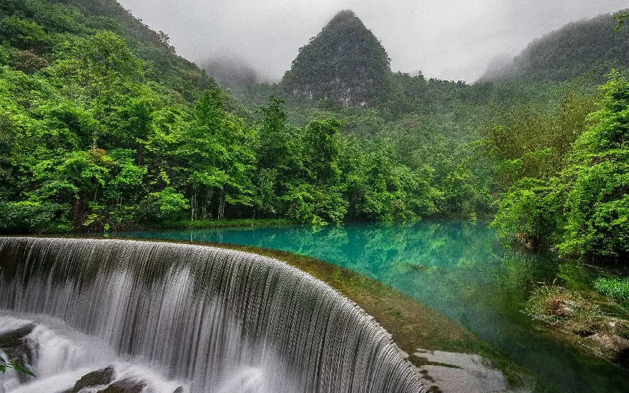 A Huge Waterfall Leading to a River in the Forest in a Beautiful Frame
