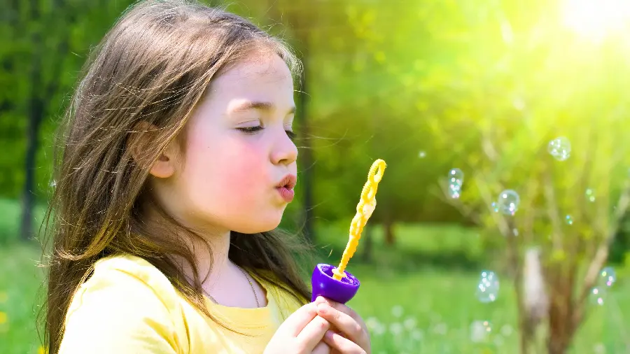 Baby girl photo making bubbles