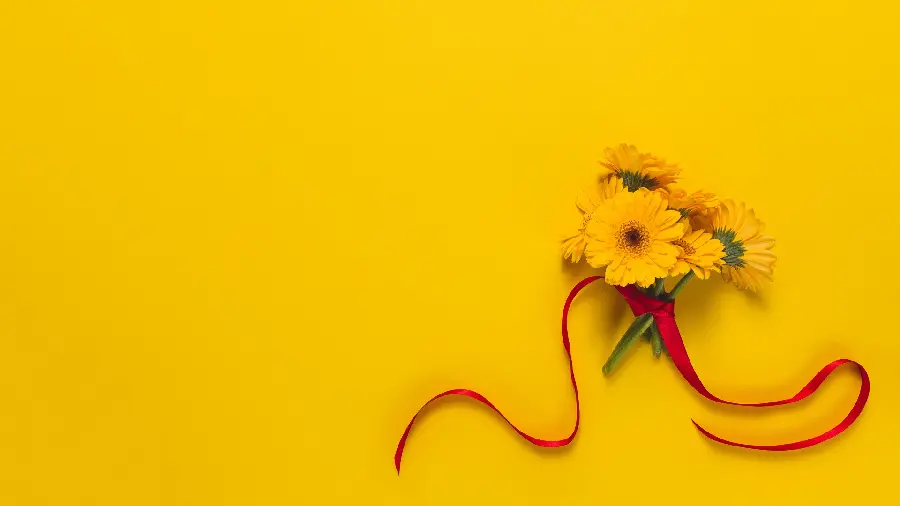 Yellow wallpaper with a flower design for computers and laptops 
