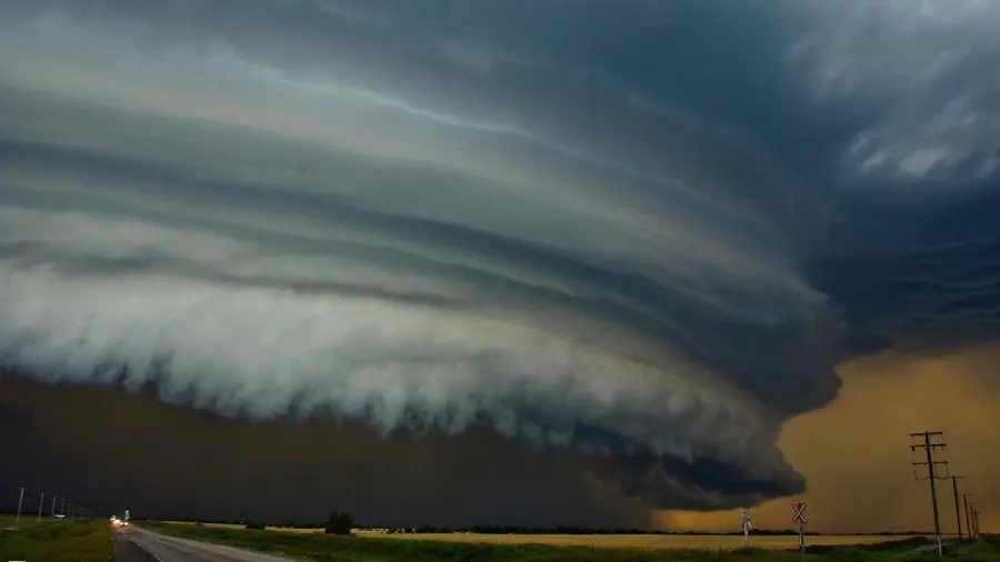 HD photo of a terrible tornado above moving cars