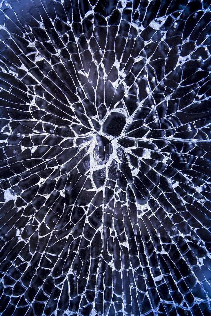 Attractive and spectacular photo of cracked glass as a background for IPhone 14