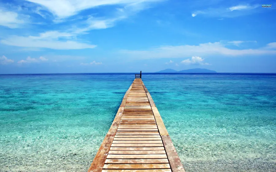 Amazing image of the blue sea of ​​Bali with a beautiful wooden bridge