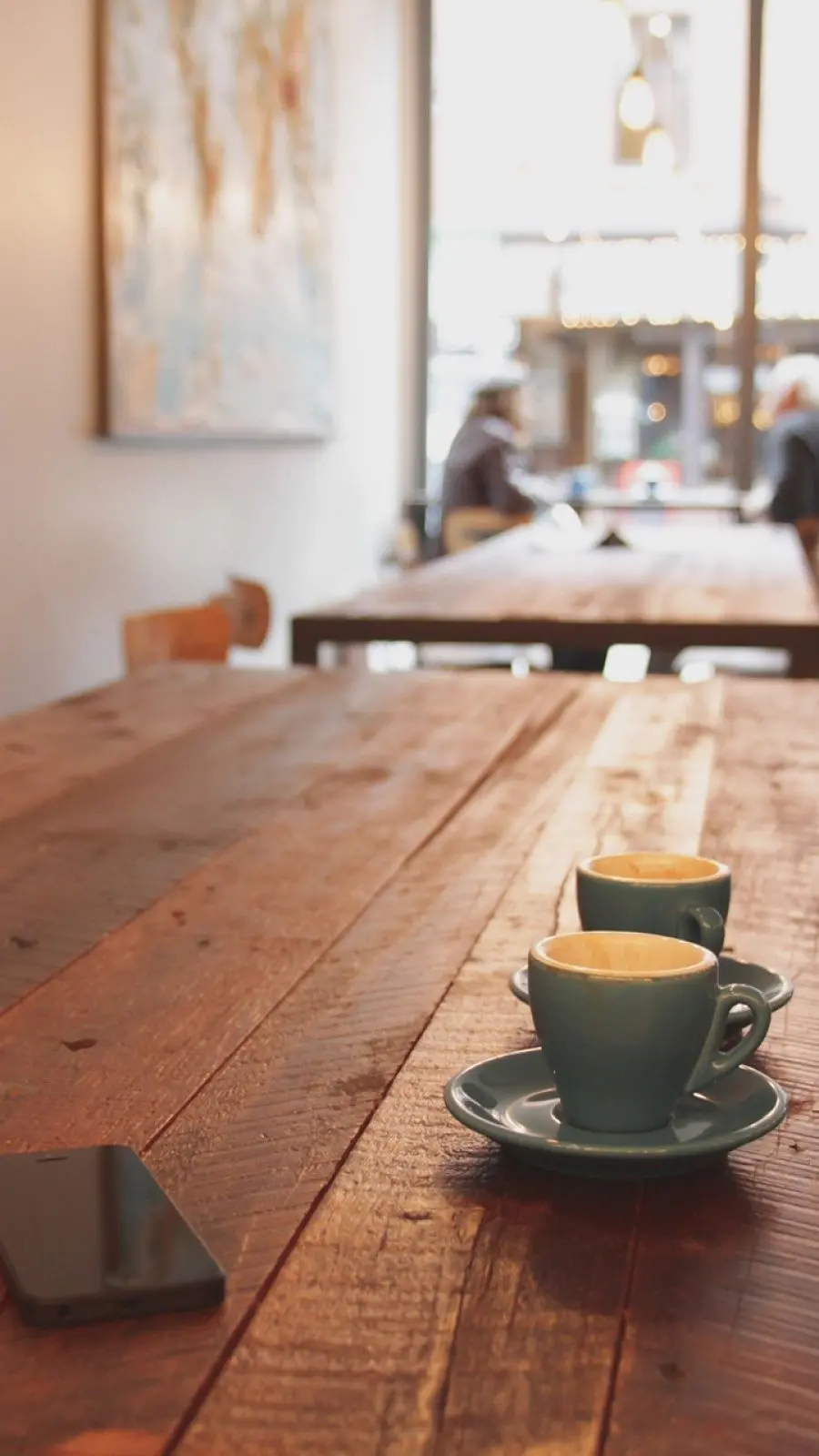 8k photo of coffee for two on a wooden table in a cozy and secluded cafe