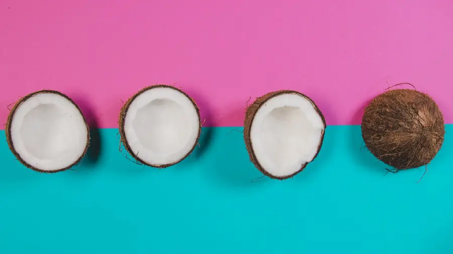 Cool and interesting background of delicious coconuts with a blue pink background