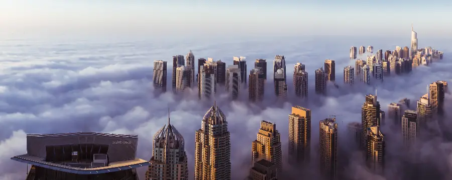 Full HD frame of Dubai skyscrapers among clouds and fog