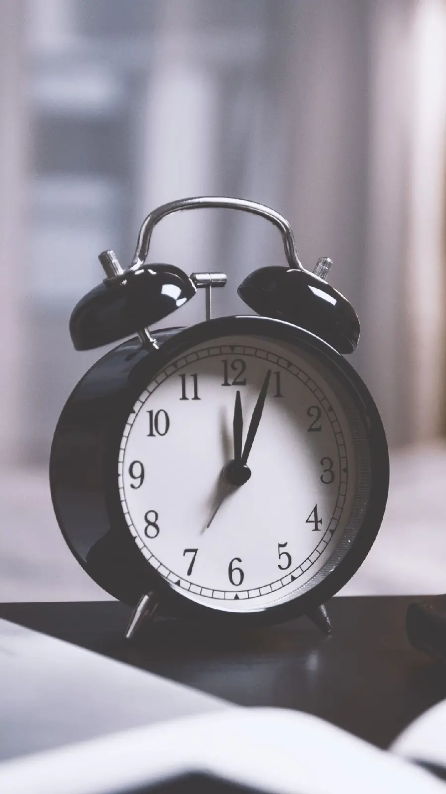 Black desktop alarm clock in an artistic frame