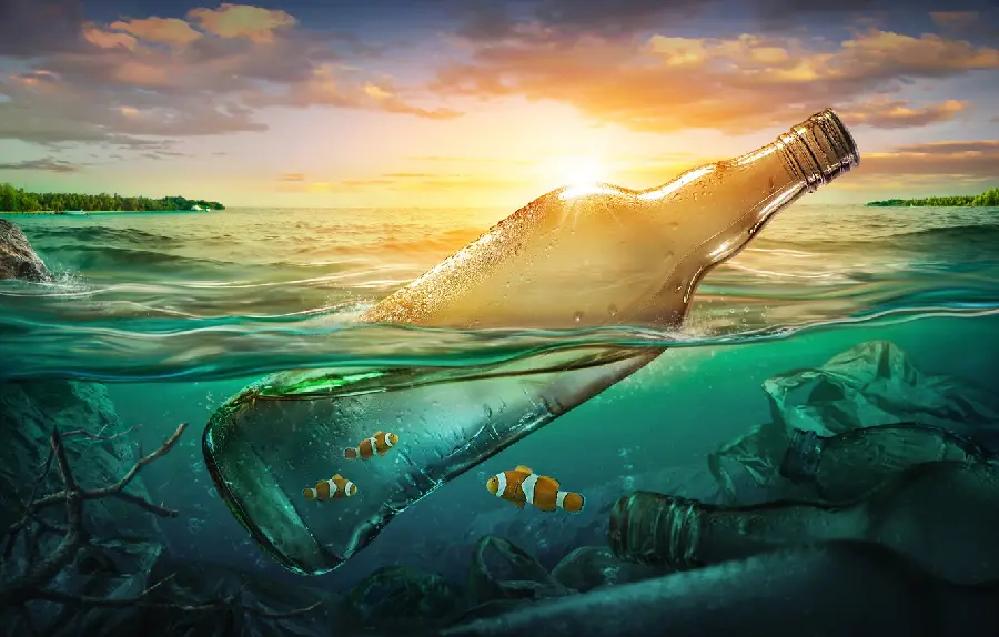 A conceptual graphic photo of a large bottle suspended in water as a sign of the danger of marine pollution