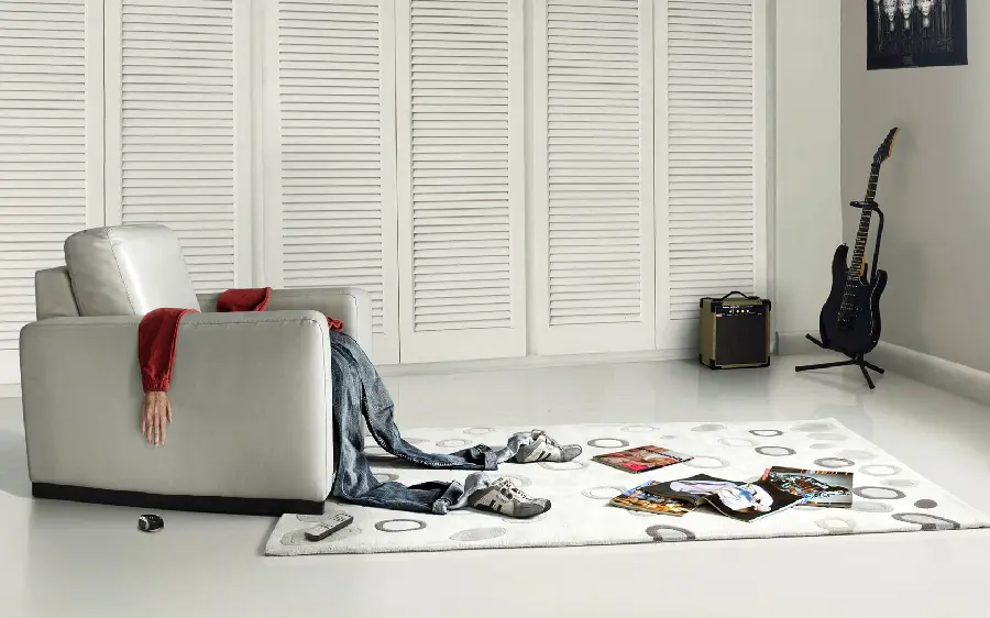 Strange and misleading picture of clothes on a sofa in the shape of a person 