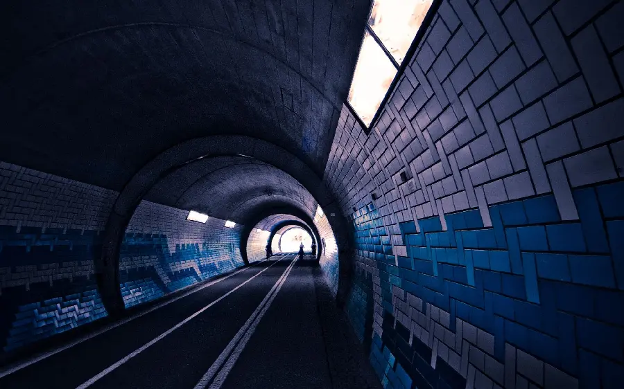 Interesting photo of a tunnel with small windows with a blue and white wall