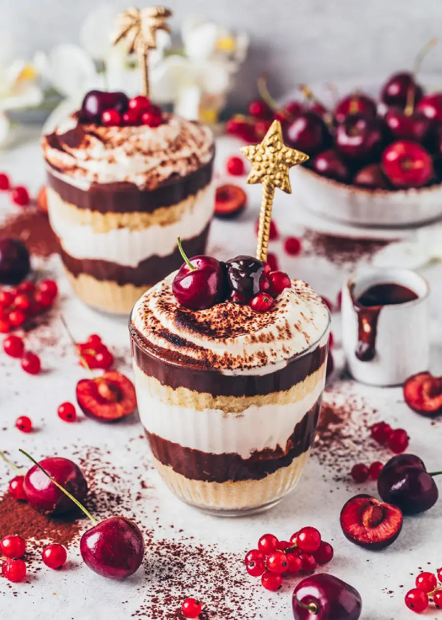 New photo of incredibly beautiful glass dessert with red cherry decoration 2023
