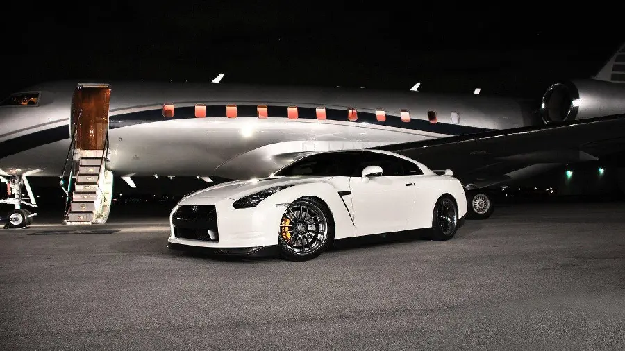 Photo of a Nissan GTR and a private plane