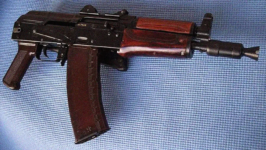 Photo of a black Uzi combat weapon on a blue background and high quality