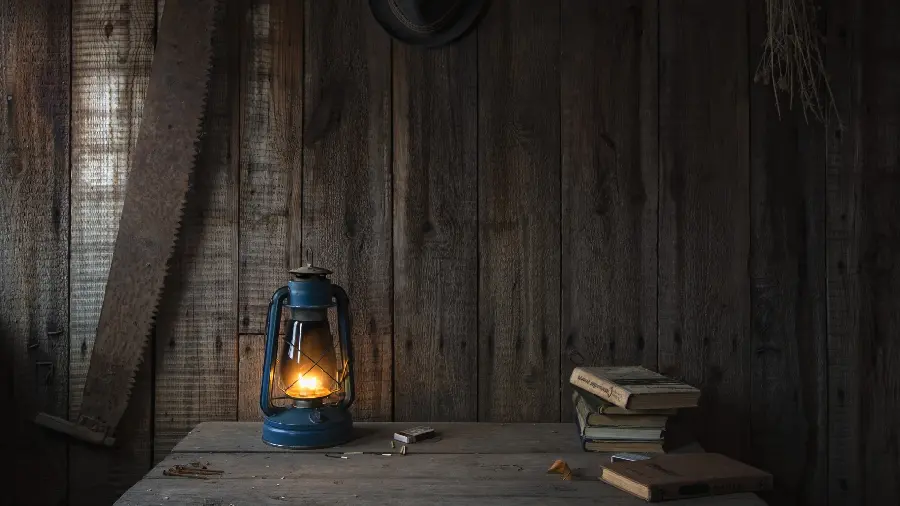 Interesting Art Frame of Book and Lighted Lantern On the desk