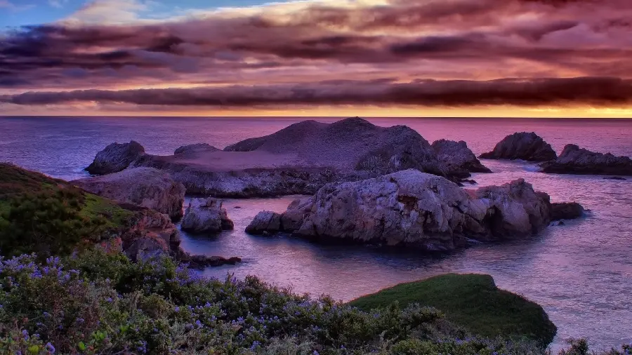 Beautiful nature background on the rocky seashore with a purple halo for the computer
