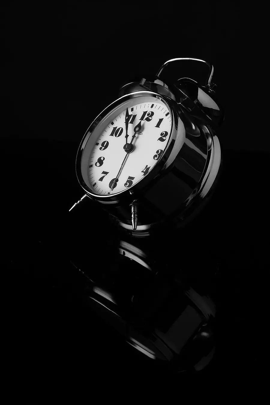 Interesting angle of a desktop alarm clock with a special black background