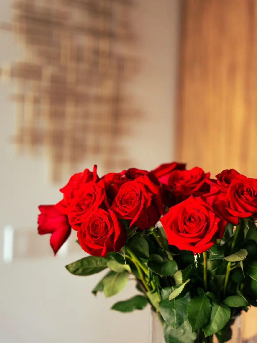 Interesting artistic photo of a cute red rose bouquet in a vase
