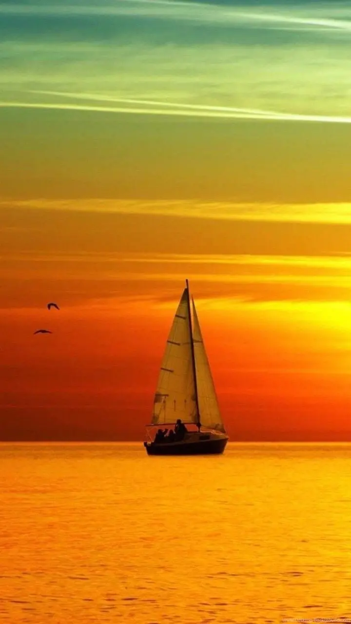Beautiful boat background at sunset in the sea in spectacular yellow, orange, green colors