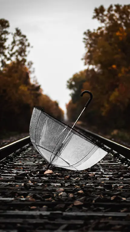 Download Profile Picture and Wallpaper of Umbrella and Rain on Train Tracks