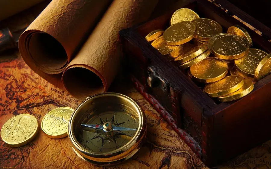 Amazing photo of an old compass next to several gold coins
