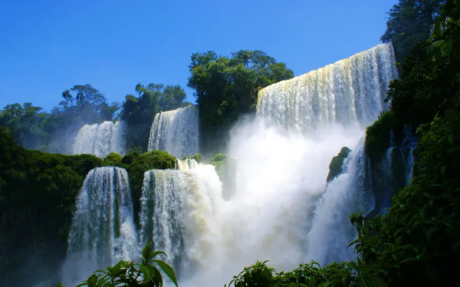 Amazing photo of a waterfall between the forest with freshness for laptop backgrounds