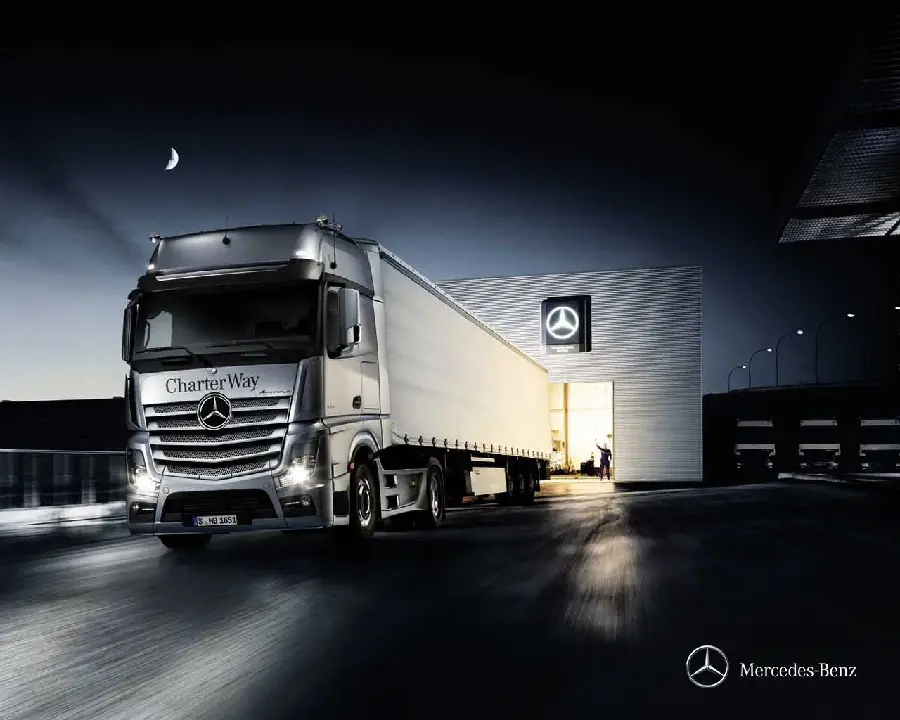 Photo of the silver Mercedes-Benz Actros truck made in Germany in a beautiful night