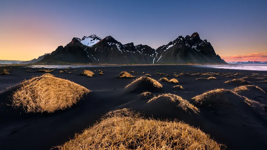 Unusual but incredibly spectacular photo of the black sea shore with straw-like plants