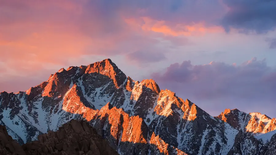 A charming and wonderful image of high snowy mountains in cloudy weather