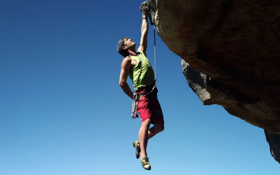 Strange and dangerous rock climbing photo of a foreign man in the mountain