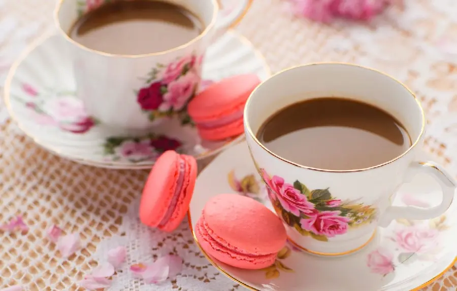 Beautiful photo of Nescafe in a rose cup and pink macarons Delicious 
