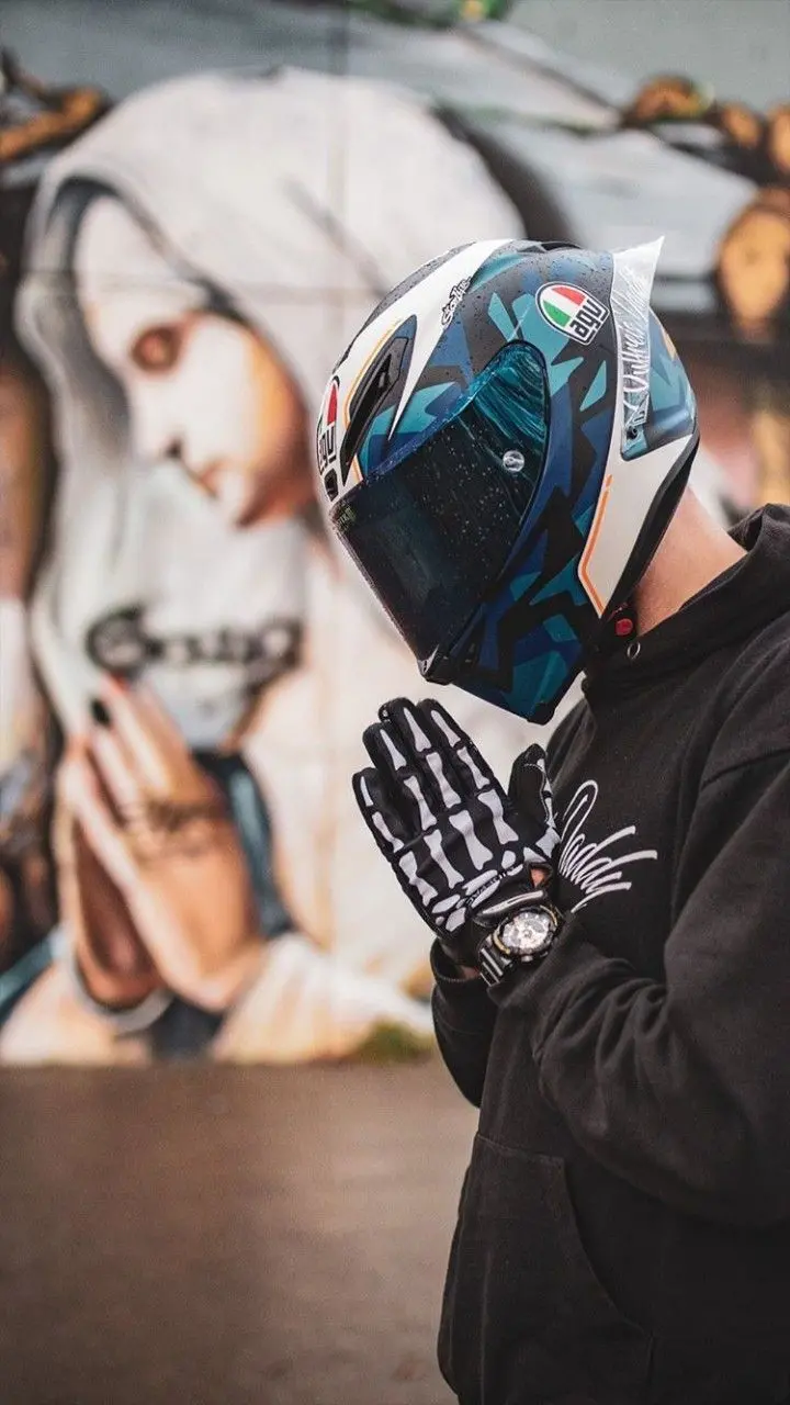 Full HD artistic photo of a man riding a motorcycle with a hand gesture of appreciation
