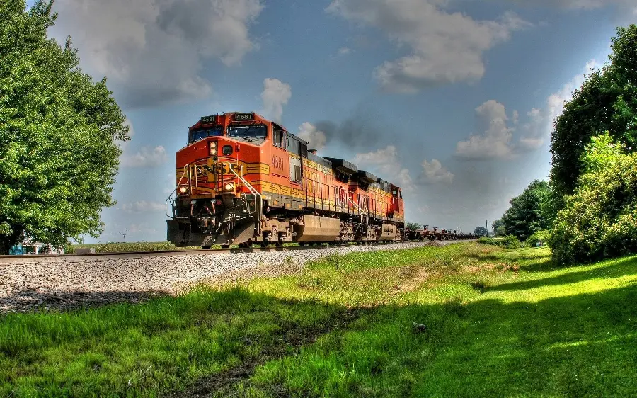 Download the image of a modern freight locomotive on a rail with a large and sturdy body