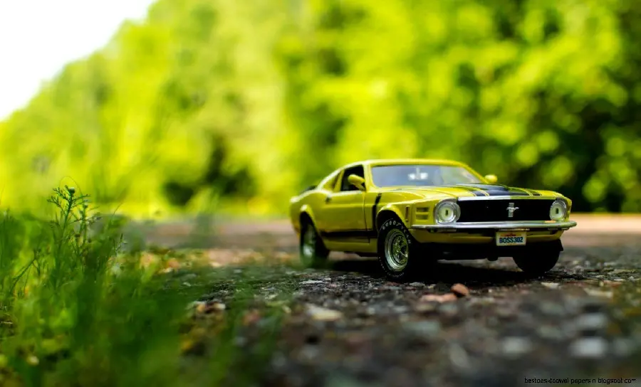 Picture of a green miniature car in the forest for car enthusiasts 