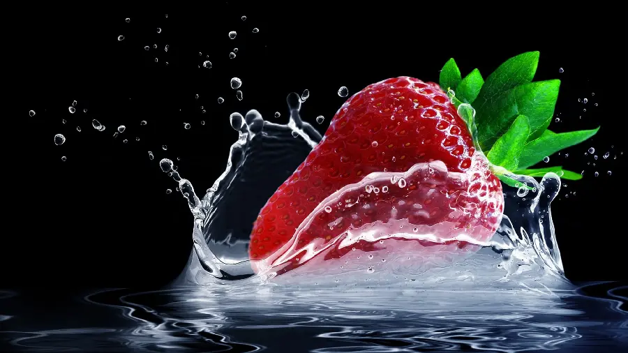 A charming wallpaper of strawberries falling into the water from a close-up
