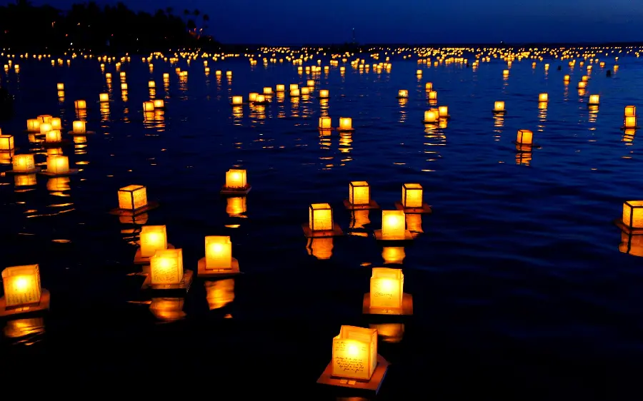 Download image of lit candles left on the water for condolences 