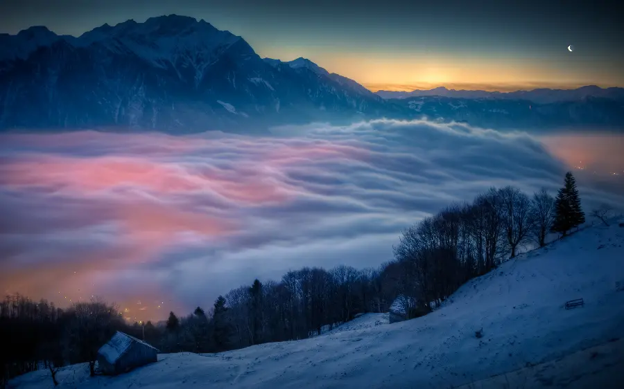 Dreamy wallpaper of a luminous city covered in fog in the heart of a snowy mountain suitable for an Instagram post