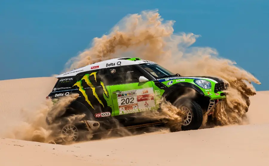 Photo of a cool green and black racing car during the spectacular Dakar Rally