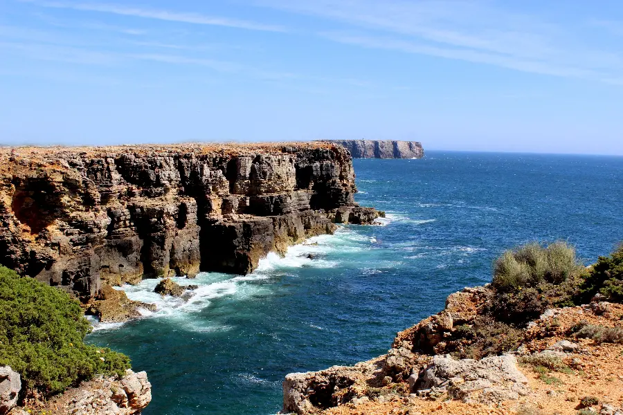 A spectacular background of a cliff and a raging ocean and a clear sky in 8K quality