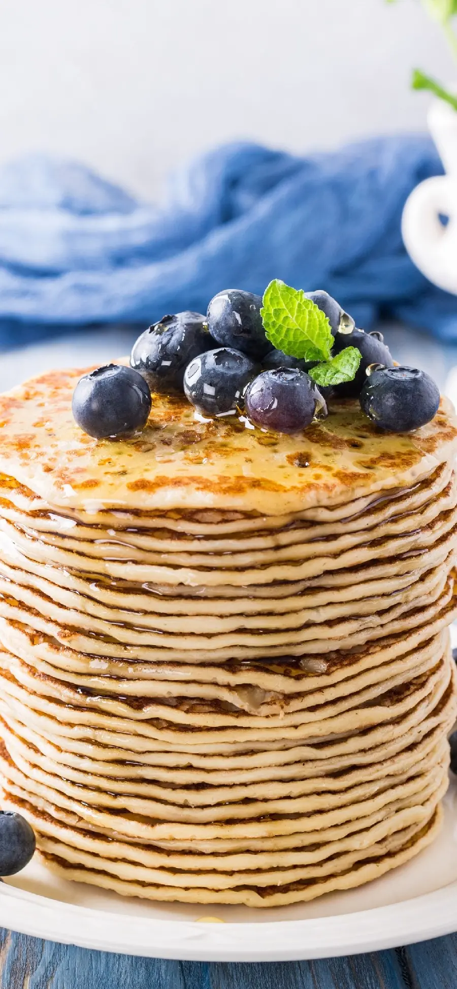 Photo of simple puffy homemade pancakes with blueberries and honey toppings 