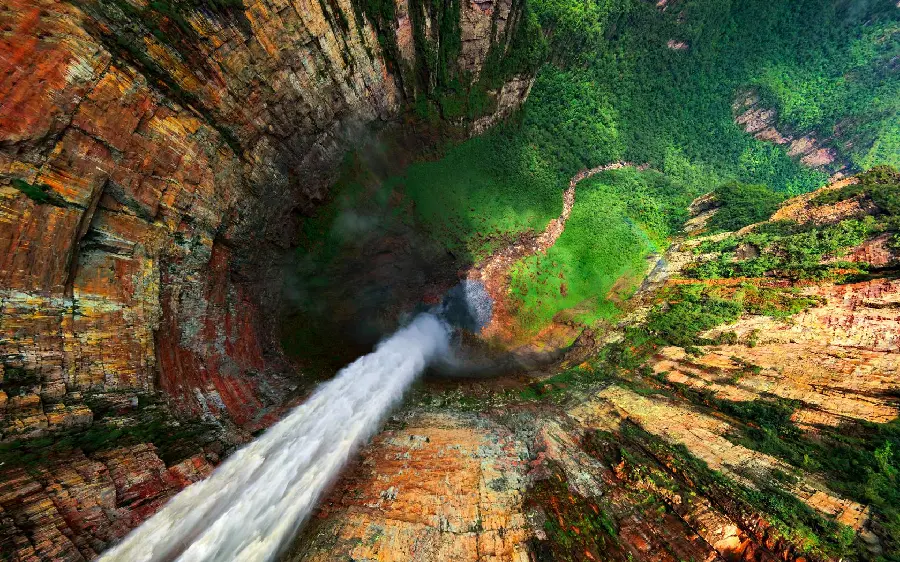Amazing image of an incredibly cool waterfall leading into a lush valley from a high angle